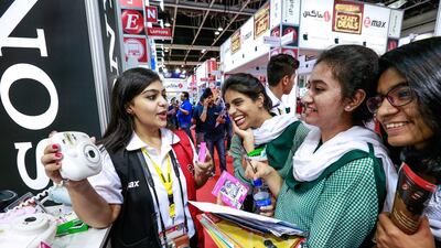 Dubai students about to purchase a polaroid camera at Gitex Shoppers Fall 2015. Victor Besa for The National