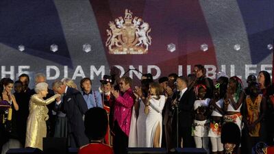 Queen Elizabeth and Prince Charles on stage with artists including Elton John and Paul McCartney during the Diamond Jubilee concert at Buckingham Palace in 2012. Getty Images
