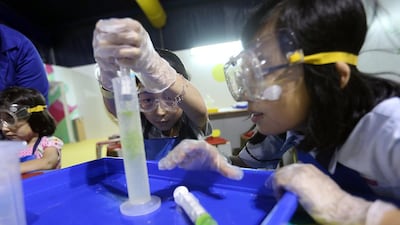 Students participate in a chemistry experiment during the Abu Dhabi Science Festival. Sammy Dallal / The National