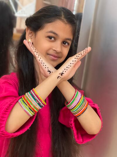 Sarah Qadir shows off the henna her mother applied when she began fasting this Ramadan. Photo: Khan family