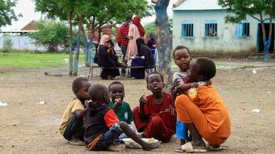 Children share a meal provided through a charity initiative at a displacement camp in Gedaref city in the east of war-torn Sudan. AFP