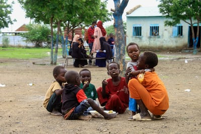 Displaced children share a meal provided by a charity at a camp in Gedaref city. AFP