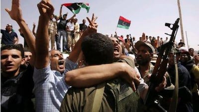 Anti-Gaddafi fighters celebrate as NTC negotiators meet tribal elders from Bani Walid in a mosque near the besieged town city, as talks resume on the peaceful surrender of one of Muammar Qaddafi's last remaining strongholds Youssef Boudlal / Reuters