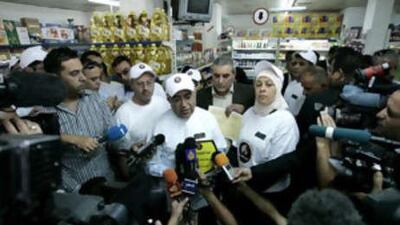 Salam Fayyad, the Palestinian prime minister, centre, talks to journalists during a visit to a supermarket in Ramallah yesterday.