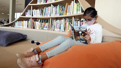 Dima, 7, reads in the children's area of the House of Wisdom. Chris Whiteoak / The National