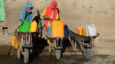 Girls filling containers with drinking water from a tap in Kandahar, Afghanistan. AFP