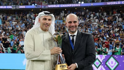 Manchester City chairman Khaldoon Al Mubarak, left, and manager Pep Guardiola pose for a photograph with the Fifa Club World Cup trophy after their team's victory over Brazilian club Fluminense in the final at King Abdullah Sports City on December 22, 2023, in Jeddah, Saudi Arabia. Getty Images