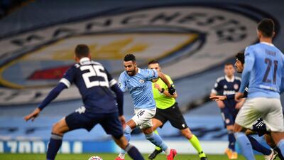 Riyad Mahrez runs with the ball during the match against Olympiakos at the Etihad Stadium. AFP