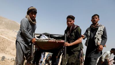 People carry the body of one of the victims of yesterday's suicide attack. Reuters