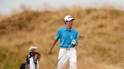 Amateur Cole Hammer pulls a club on the 11th hole. Ross Kinnaird / Getty Images / June 18, 2015