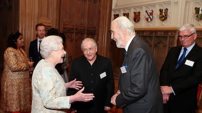 Queen Elizabeth speaks to British actor Christopher Lee. Getty