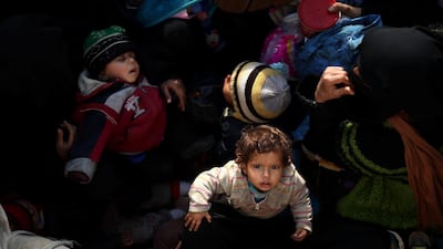 The women and children, some just months old, are driven hundreds of kilometers across the country to SDF run displacement camps. AFP