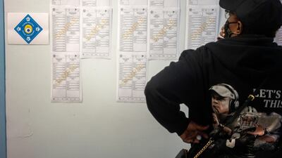 A woman looks at sample ballots while waiting at City Hall to cast her ballot for the upcoming presidential election as early voting begins in New Orleans, Louisiana. Reuters