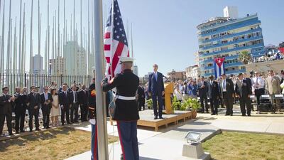 Secretary of state John Kerry (C) stands with other dignitaries as members of the US marines raise the American flag over the newly reopened embassy in Havana, Cuba on August 14, 2015. Pablo Martinez Monsivais