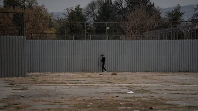A migrant next to the wall of the Harmanli migrant processing camp, Bulgaria's largest. Getty