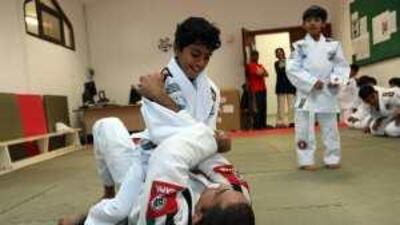 Rashed Daood, 12, practises a hold on his instructor, Marcelo Freitas, at Zayed al Thani school in Abu Dhabi.