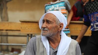 An elderly displaced Kurdish man who fled from Ras al-Ain city sits with children at temporary shelter in a school building at Tal Tamr town, northeast of Syria. Turkey has launched an offensive targeting Kurdish forces in north-eastern Syria, days after the US withdrew troops from the area. EPA
