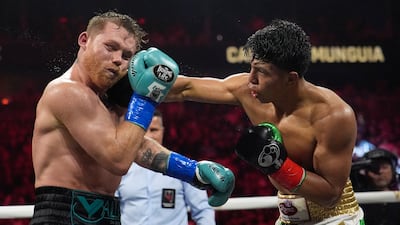 Jaime Munguia lands a punch on Canelo Alvarez. AP