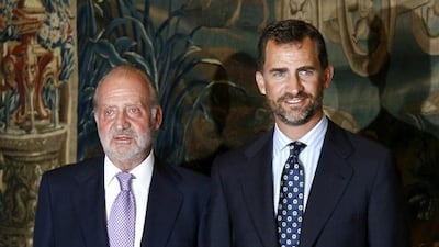 File photo taken on August 28, 2009 shows Spain’s King Juan Carlos, left, and Prince Felipe at a summer dinner at Almudaina Palace in Palma de Mallorca. Jaime Reina/AFP Photo