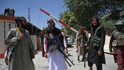 Taliban fighters stand guard along a roadside near the Zanbaq Square in Kabul. AFP