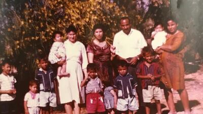 Majida, aged 9 months, is carried by her mother, in white, with two other families who lived in the camp in Sharjah in 1966.