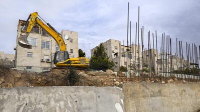 Earth moving equipment stands in the Israeli settlement of Ramat Shlomo near Jerusalem. Jim Hollander / EPA
