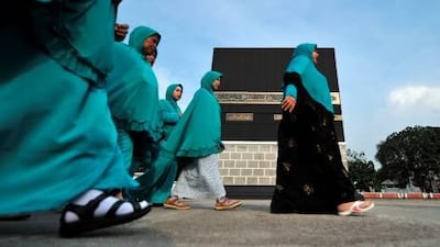 Indonesian pilgrims practise before a replica of the Kaaba, Islam's holy shrine, at a training centre in Jakarta as part of their final preparations before departing for the Haj.