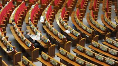 A deputy of Yulia Tymoshenko's bloc reads a newspaper as he sits alone in the Ukrainian Parliament on Sept 16 2008.