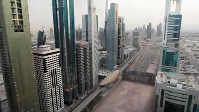 A computer-generated image from the television show Strip the City, shows Sheikh Zayed Road in Dubai being rolled up like a carpet to reveal deep sand beneath. Courtesy Discovery Channel