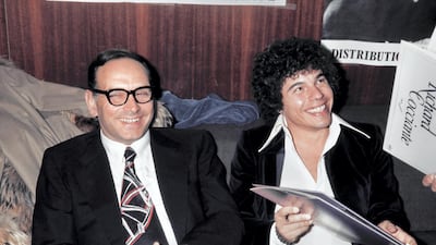Italian composers Ennio Morricone (L) and Richard Cocciante at the Olympia in Paris on October 1, 1974. AFP