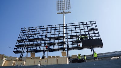 Technicians work on the scoreboard at the Qaddafi Stadium in Lahore. Reuters