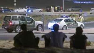 Racing fans and the police surround the Al Warqa roundabout in Dubai.