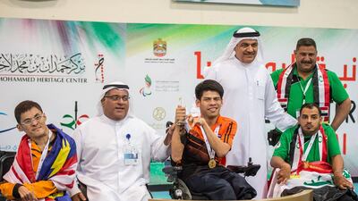 Pattaya Tadtong of Thailand, centre, Lean Chin Kit of Malaysia, left, and Mohamed Fadhel Jiad of Iraq, right, are awarded their medals for the BC1 discipline at the Fazza International Boccia Competition in Dubai. Photo Courtesy / HHC Media