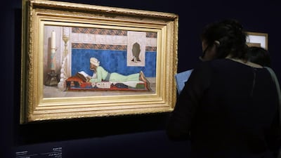 A woman looks at a painting by Osman Hamdi Bey entitled ‘The young emir studying’ (Istanbul, 1878). Francois Guillot/AFP