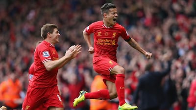 Philippe Coutinho of Liverpool celebrates scoring his team's third goal during the Premier League match between Liverpool and Manchester City at Anfield on April 13, 2014 in Liverpool, England. Alex Livesey/Getty Images