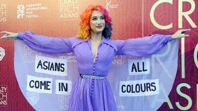 Burlesque performer Sukki Singapora poses for photographers as she arrives for the red carpet screening of the movie 'Crazy Rich Asians' on August 21, 2018, in Singapore. Don Wong / AP photo