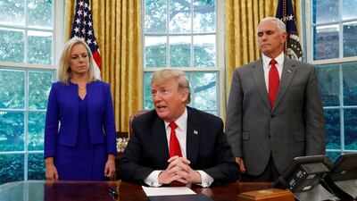 Donald Trump speaks to reporters about signing an executive order on immigration policy with DHS Secretary Kirstjen Nielsen and Vice President Mike Pence at his side. REUTERS/Leah Milllis