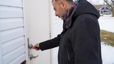 Imam Taha Tawil unlocks the back door of the mosque in Cedar Rapids, Iowa.