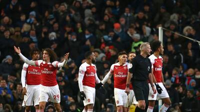 Arsenal players react after Aguero scored his side's third goal. AP Photo