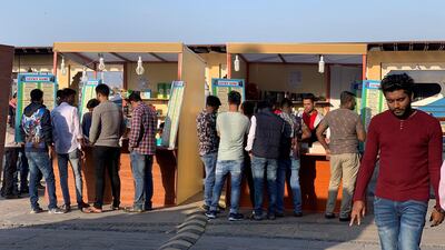 Players enter bets to win prizes in 'Lucky Game' kiosks near Dubai Creek last week, before they were shut down. Pawan Singh / The National