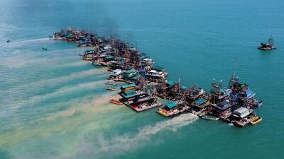 A drone camera captures wooden pontoons equipped to dredge the seabed for deposits of tin ore off the coast of Toboali, on the southern shores of Bangka, Indonesia. Reuters