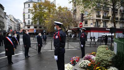 Anne Hidalgo and Jean Castex lay flowers outside La Bonne Biere cafe. EPA