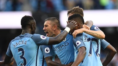 Manchester City defender Aleksandar Kolarov (C) celebrates with teammates after their second goal, an own goal scored by Sunderland defender Paddy McNair during the Premier League football match between Manchester City and Sunderland at the Etihad Stadium in Manchester, north west England, on August 13, 2016. Paul Ellis / AFP