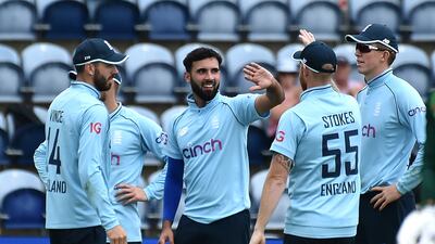 England's Saqib Mahmood, centre, celebrates with teammates after dismissing Pakistan's Faheem Ashraf during the first ODI in Cardiff, Wales, on Thursday, July 8, 2021.
