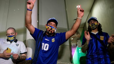 Supporters of Diego Maradona gather outside the hospital where he undergoes a brain surgery for a blood clot, in Olivos, Buenos Aires. AFP