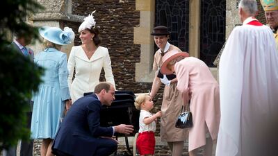 Having a word with his great-grandmother Queen Elizabeth II at the July 2015 christening of Princess Charlotte on the Sandringham estate. Getty Images