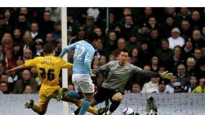 Carlos Tevez, centre, takes the ball past the Notts County keeper to score Manchester City's third goal yesterday. Dean Mouhtaropoulos / Getty Images