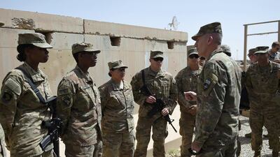 The US commander in Afghanistan John Nicholson (R) talks with soldiers ahead of a handover ceremony in Lashkar Gah, Helmand. AFP