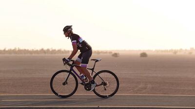 Emma Woodcock cycles even through the hot summer months to keep fit. Seen here during a ride at the Al Qudra track near Bab Al Shams. Antonie Robertson / The National