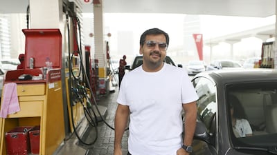 Bharat Grover fills up his BMW 3 Series at an Eppco near Tecom in Dubai on the first day of the fuel price increase. Sarah Dea / The National
